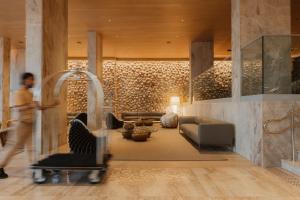 a man walking through a living room with a couch at Venti Hotel - By Brisa Hotéis - Soft Opening in Maceió +94 photos