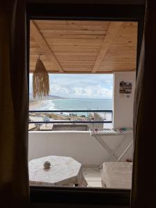 a view of the ocean from a room with a window at Adar surf house in Taghazout