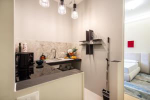 a kitchen with a counter top and a refrigerator at Piramide Deluxe Apartment in Rome +149 photos