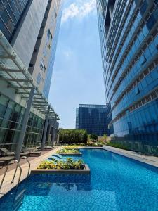a large swimming pool between two tall buildings at Parksuites Tower 2 in Manila