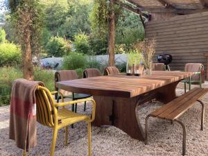 a wooden table and chairs sitting around a wooden table at Encore une fois, Entre deux in Locmalo