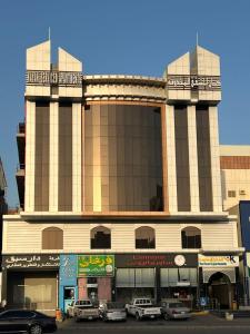 a large building with cars parked in front of it at شقق كيان للشقق المخدومه in Jeddah