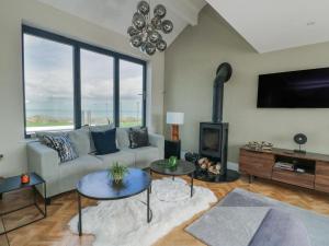 a living room with a couch and a fireplace at Pengarnedd in Amlwch
