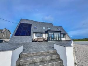 a house with a solar panel on the roof at Pengarnedd in Amlwch