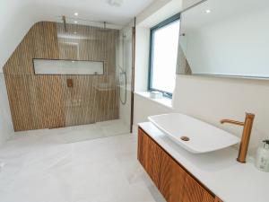 a bathroom with a sink and a shower at Pengarnedd in Amlwch +40 photos