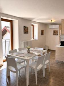 a white dining table and chairs in a kitchen at Rustico Maria Full House Lake View Escape in Vercana