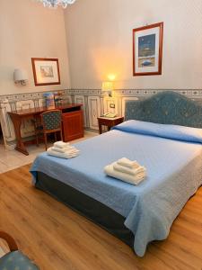 a bedroom with a bed with towels on it at City Hall in Catania