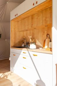 a kitchen with white cabinets and a sink at 53 North in Bodham