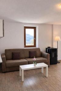 a living room with a couch and a coffee table at Rustico Maria Full House Lake View Escape in Vercana