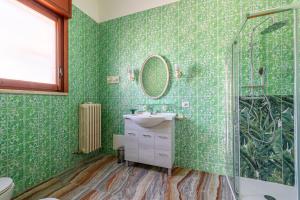 a green bathroom with a sink and a shower at Villa dei Domenicani in Copertino +59 photos