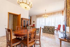 a dining room and living room with a table and chairs at Villa dei Domenicani in Copertino
