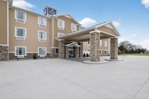 a large building with a parking lot in front of it at Cobblestone Hotel & Suites - Eaton in Eaton