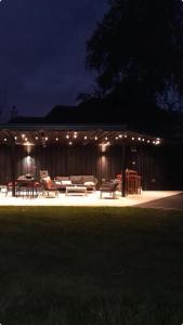 a building with a patio at night with lights at Lough View Lodge in Ballyronan