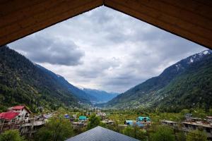 a view of a town in a valley with mountains at Hotter Potter Stays Manali in Vashisht