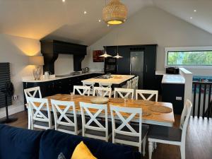 a kitchen and dining room with a table and chairs at Lough View Lodge in Ballyronan