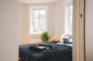 a bedroom with a bed with a tray on it at Urban Centre in Bergen