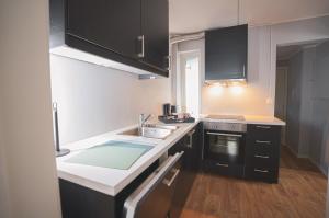 a small kitchen with a sink and a stove at Urban Centre in Bergen