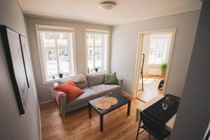 a living room with a couch and two windows at Urban Centre in Bergen