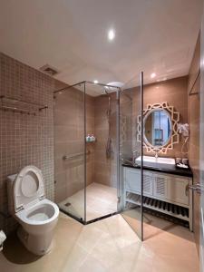 a bathroom with a toilet and a sink and a mirror at Camly Chic Villa in Da Lat +40 photos