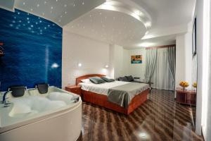 a hotel room with a bed and a bath tub at Villa Maki in Ohrid