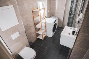 a bathroom with a toilet and a sink at Urban Centre in Bergen +9 photos