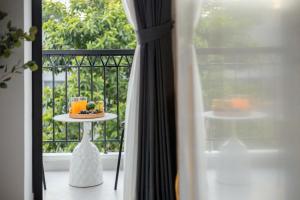 a plate of fruit on a table on a balcony at Artsy Boutique Studio in Hanoi