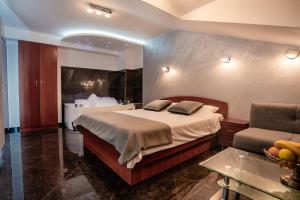a hotel room with a bed and a couch at Villa Maki in Ohrid