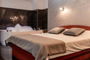 a bedroom with a large bed with white sheets and pillows at Villa Maki in Ohrid