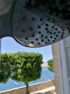 a rear view mirror with a view of a tree at Sea Balcony House in Senglea +3 photos