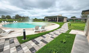 a swimming pool with two chairs and a fountain at Lagoon Miramar in Miramar +57 photos