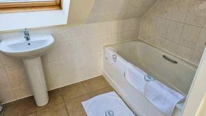 a bathroom with a sink and a bath tub next to a white sink at 12A-1 Stobhill Road in Arniston +36 photos