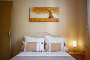a bedroom with a bed with a picture on the wall at Villa Eytychia in Kefallonia +15 photos