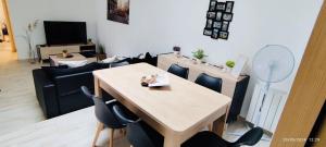 a living room with a wooden table and chairs at Cognac Gare Classé 3 in Cognac