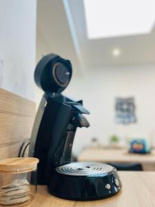 a black coffee maker sitting on top of a counter at Cognac Gare Classé 3 in Cognac