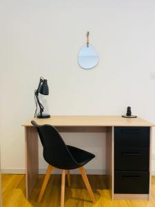 a desk with a black chair and a lamp at Cognac Gare Classé 3 in Cognac +31 photos