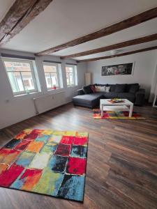 a living room with a couch and a rug at Fewo's kleine Auszeit in Quedlinburg