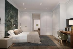 a bedroom with a bed and a desk and a desk at Hotel Rhin Garden in Santander +29 photos