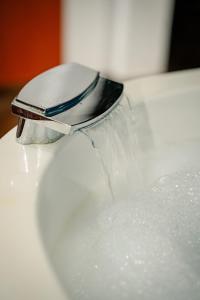 a cell phone sitting on top of a white sink at Villa Maki in Ohrid +63 photos