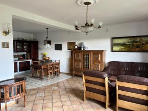 a living room with a couch and a table at Siedlisko Studzianki in Studzianki Pancerne