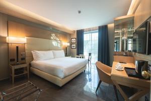 a hotel room with a bed and a desk at Hotel Forum in Pompei +86 photos