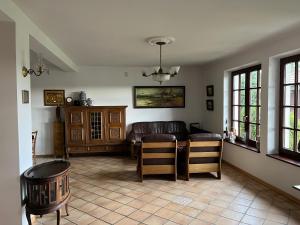 a living room with a couch and a table and chairs at Siedlisko Studzianki in Studzianki Pancerne