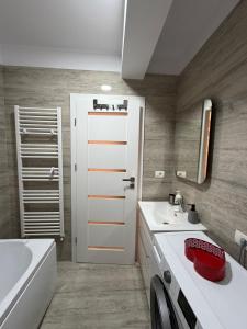 a bathroom with a sink and a toilet and a tub at Natalia Apart in Alba Iulia +23 photos