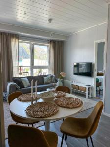 a living room with a table and chairs at Mountain and Sea View Svolvær in Svolvær