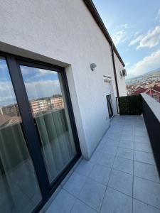a balcony of a white building with large windows at Natalia Apart in Alba Iulia