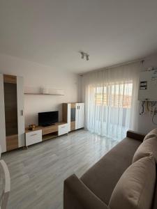 a living room with a couch and a television at Natalia Apart in Alba Iulia