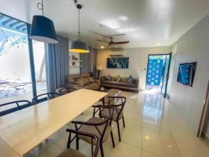 a living room with a long table and chairs at Villas 930 Oceanami in Long Hai