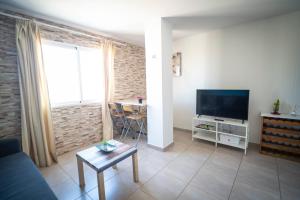 a living room with a couch and a television at Edificio Prieto VIV 4 in Puerto del Rosario