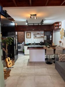 a large kitchen with a large island in a room at Chalé da Praia Paraty in Paraty