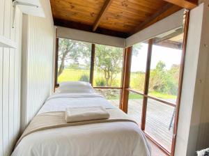 a bedroom with two beds and a large window at Prom Coast Oasis - Sandy Point in Sandy Point
