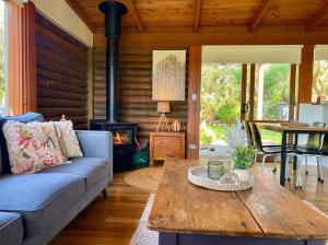 a living room with a couch and a table at Prom Coast Oasis - Sandy Point in Sandy Point